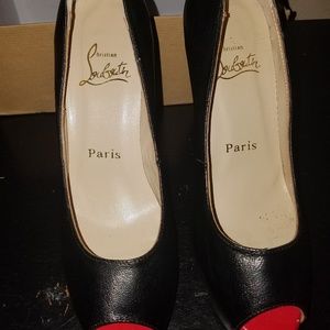 Classic black leather peep toe heels.